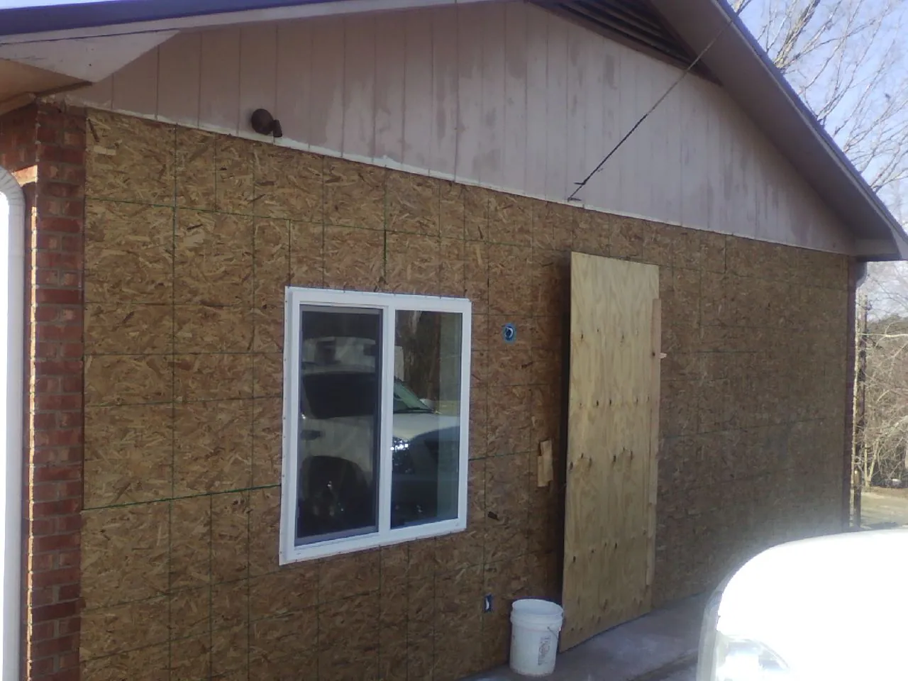 OSB sheathing on a garage addition wall before siding in Paramount